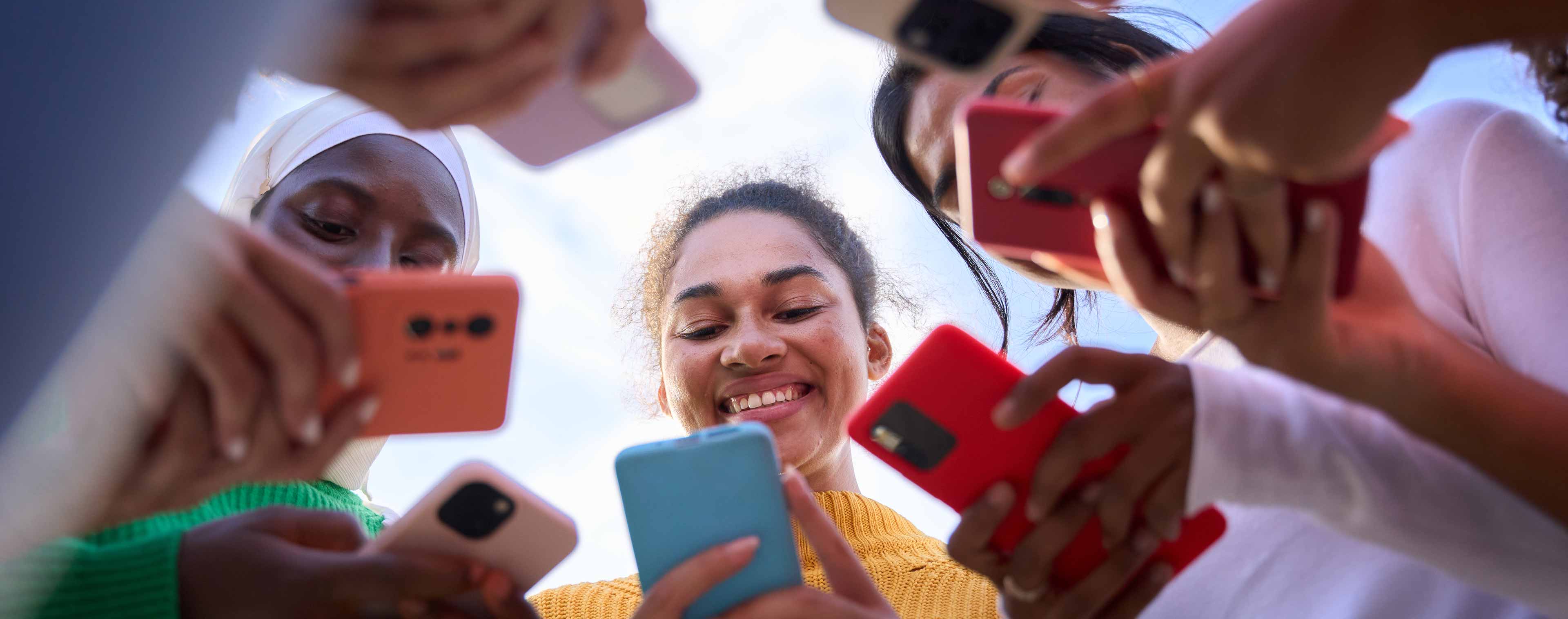 low angle group of multiracial young women smiling