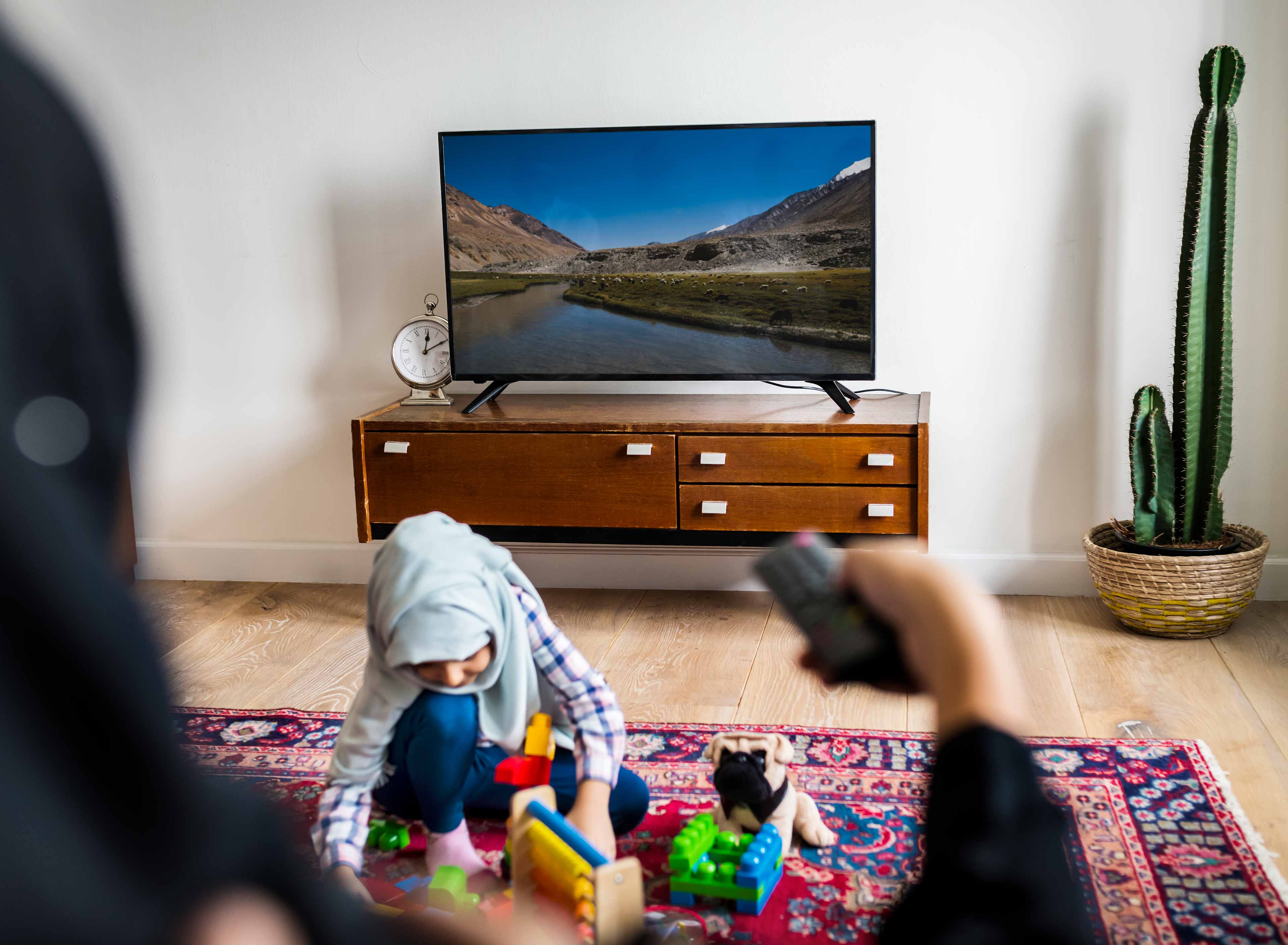 muslim family relaxing and playing at home