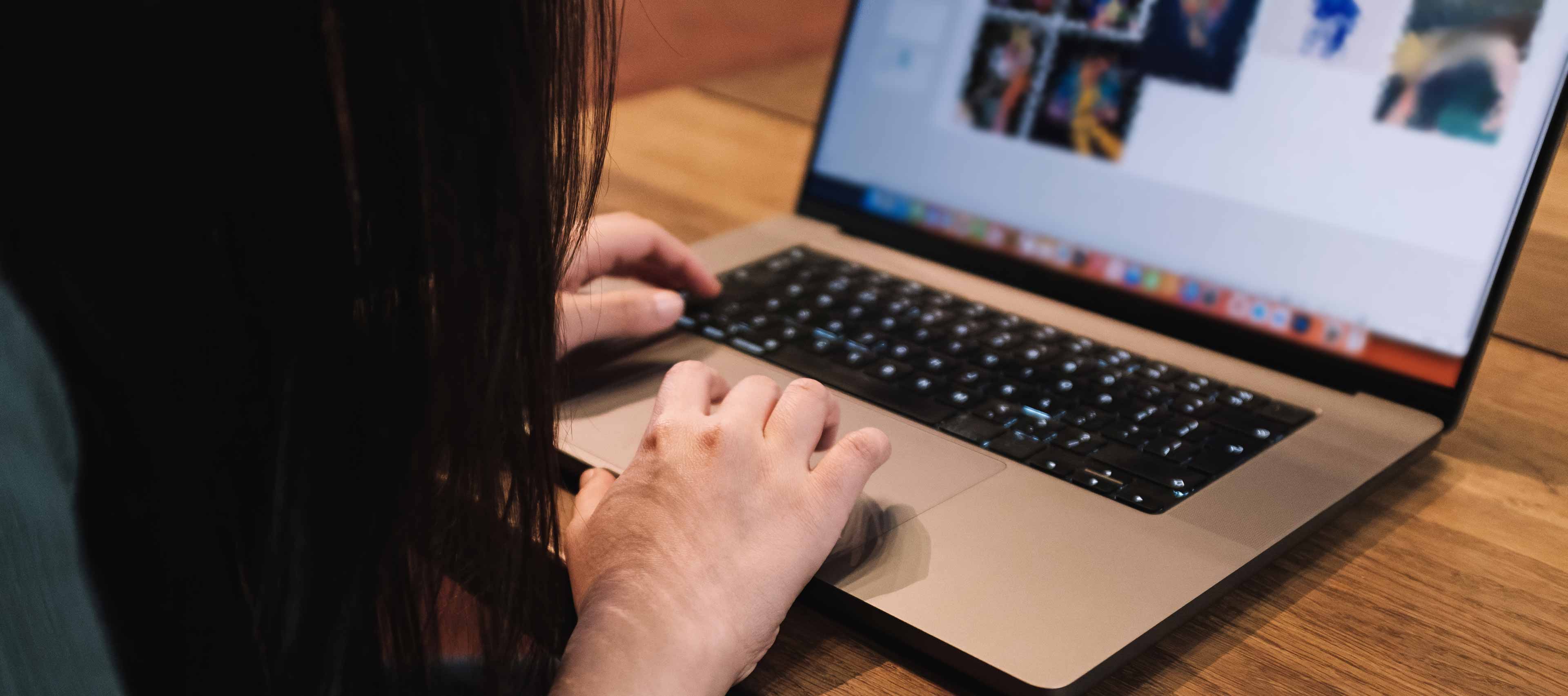 woman focused work on laptop in modern cafe