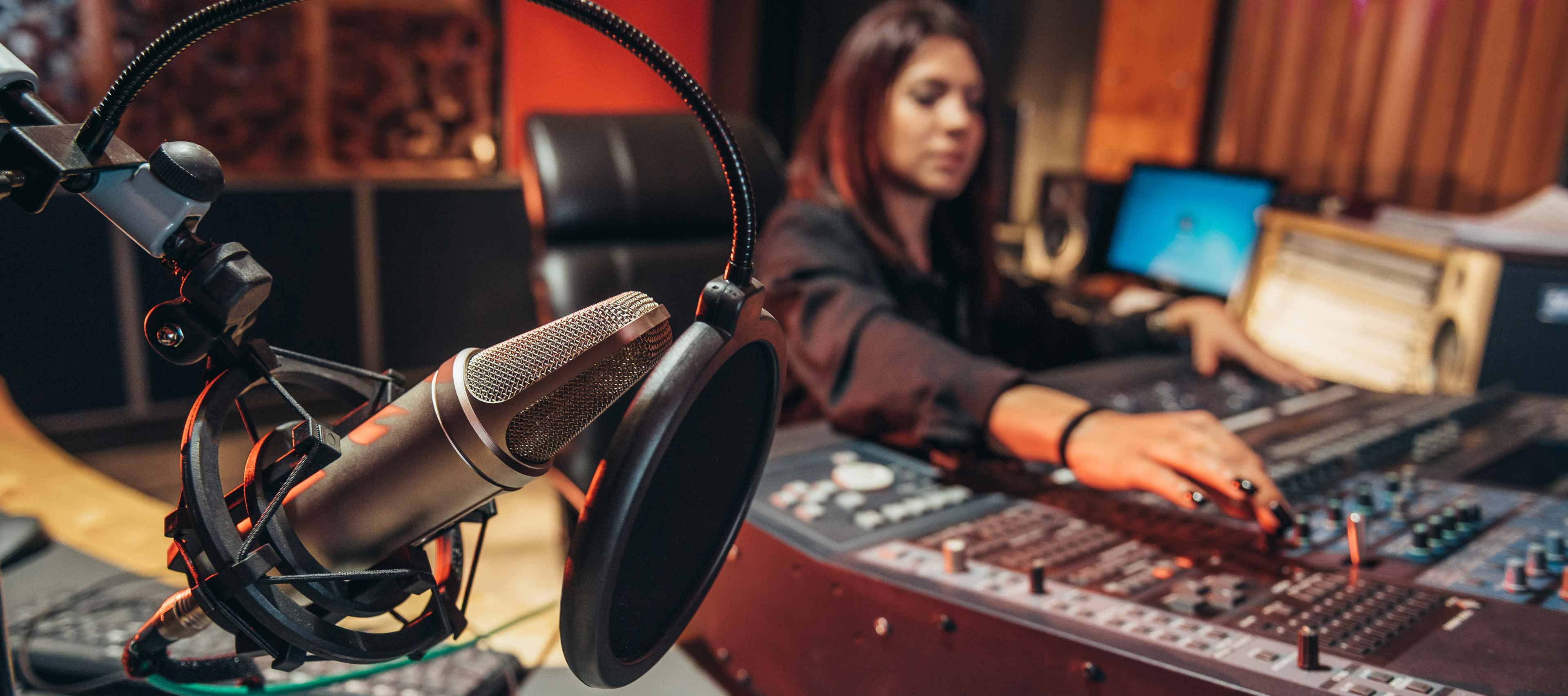 young woman music producer working on a